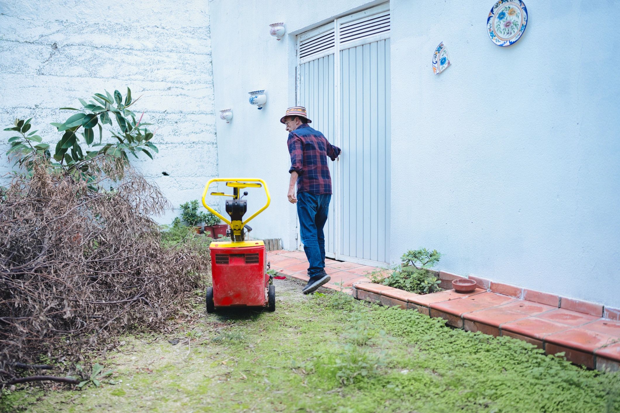 Person doing yard work with a wood chipper